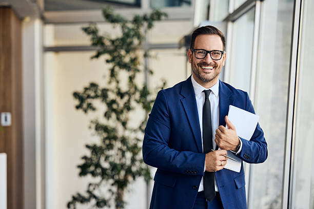 istock Confident Businessman Smiling in Modern Office Environment With Tablet in Hand 2206511265