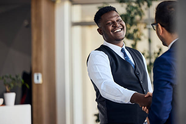 istock Friendly Business Interaction With Smiling Professional Shaking Hands in Workplace Setting 2206511291