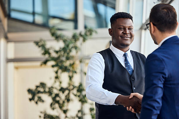 istock Two Business Professionals Shaking Hands in a Corporate Office Setting 2206511292