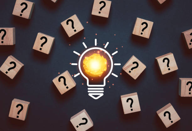 istock Glowing light bulb from yellow scrap paper among question mark for focus and concentrate of creative thinking idea and problem solving concept. 2206511385
