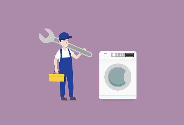 istock repairman with wrench repairing washing machine 2206515079