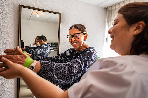 Physical therapist helping patient to do stretching exercises at home