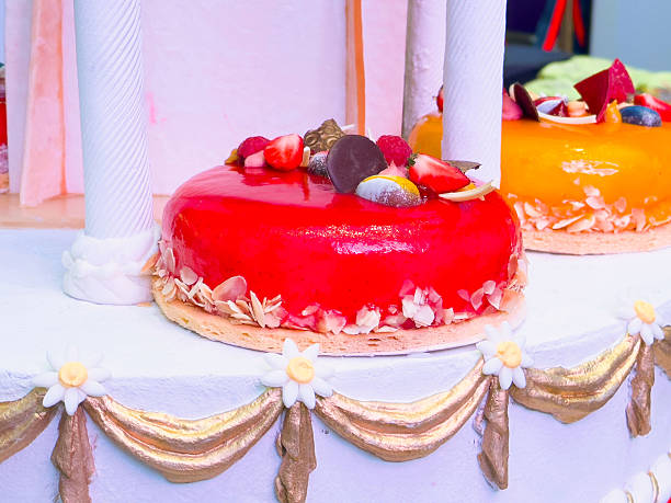 istock Delicious glazed cakes with fresh fruits in a celebration setting 2206517154