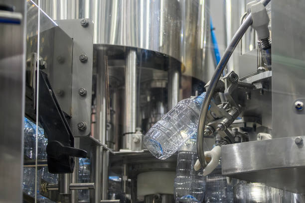 istock The  empty drinking water bottles  hanging on the conveyor belt for filling process. 2206517687