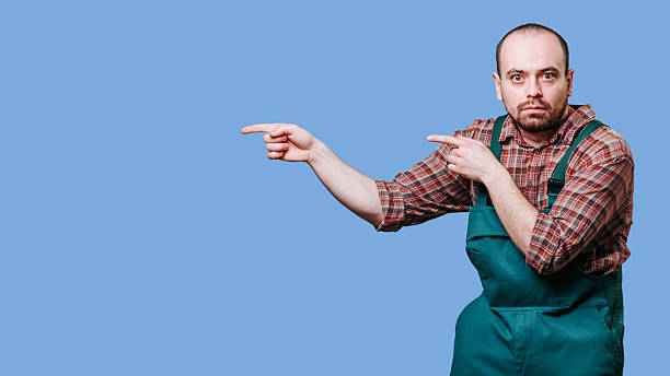 istock Man in work attire gestures towards unseen object with a serious expression 2206518053