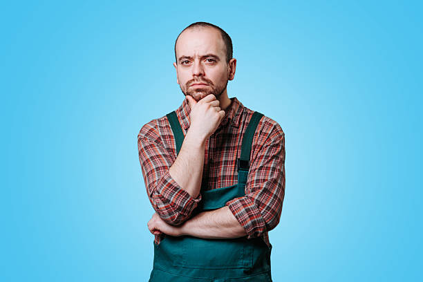 istock Thoughtful male farmer considering ideas against a bright blue background 2206518084