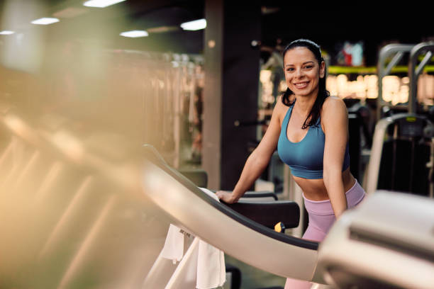istock Athletic woman taking a break on treadmill after running workout 2206518187
