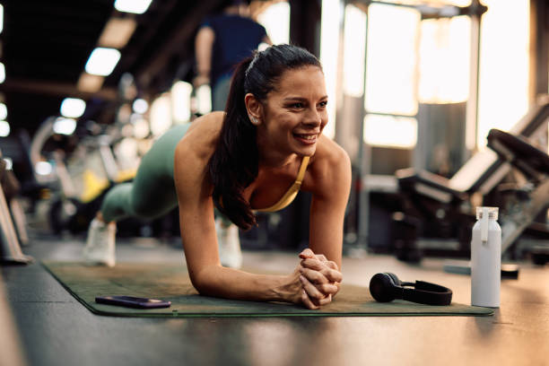 istock Determined sportswoman doing plank exercise in the gym 2206518372