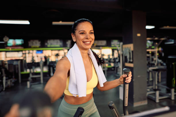 istock Smiling sportswoman taking a selfie while using elliptical trainer at the gym 2206518426