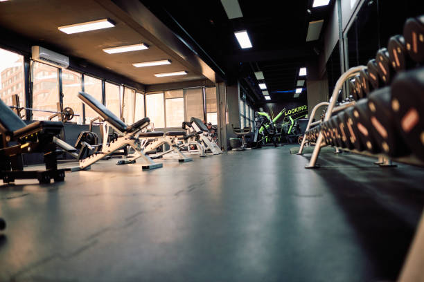 istock Empty gym with exercise equipment and weights waiting for athletes 2206518500
