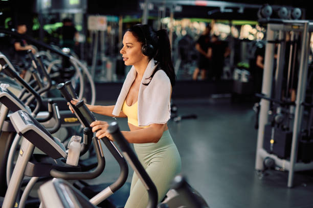 istock Determined sportswoman training on elliptical cross trainer in gym 2206518570