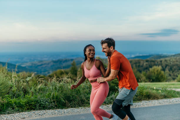 istock Happy couple running and having fun on a mountain road 2206521038