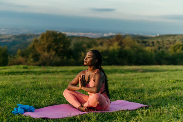 istock Young woman practicing yoga in nature enjoying a peaceful sunset 2206521966