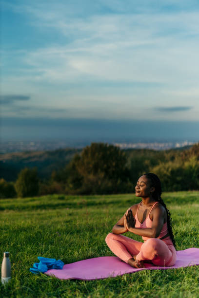 istock Young woman practicing yoga in nature at sunset 2206521967