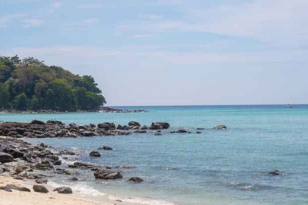 istock Tropical beach with rocks and clear turquoise water under a bright sky. 2206522020