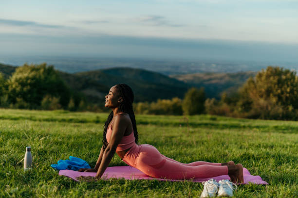 istock Young woman practicing yoga upward facing dog pose in nature 2206522050