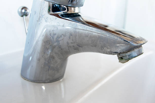 istock Metal tap with much water  limescale water in bathroom. 2206522700