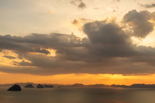 istock Golden sunset over the ocean with islands and dramatic clouds 2206522725