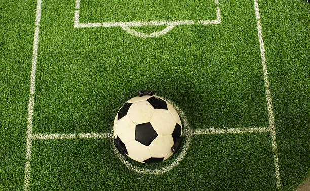 istock Soccer ball on grass top view. White markings on grass 2206522994