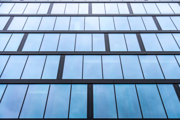 istock Glass building facade with blue-tinted reflective windows 2206523194