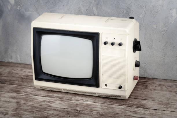 istock Analog small TV set stand on wooden floor front concrete wall background. 2206524237