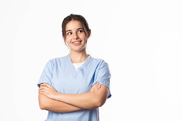 istock Young nurse smiling and looking away with crossed arms 2206525247