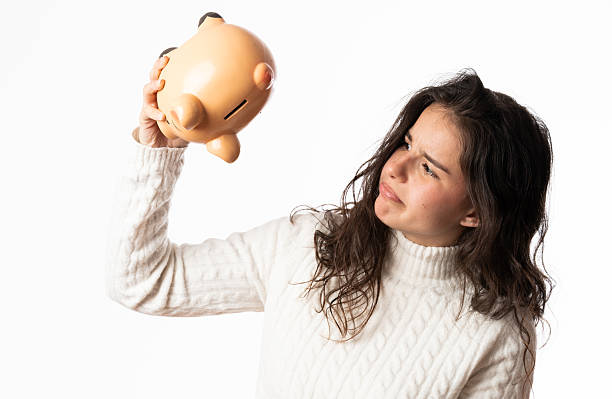 istock Young woman shaking empty piggy bank on white background 2206525450
