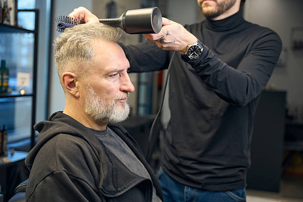 istock Barber using hairdryer at beauty salon 2206525733
