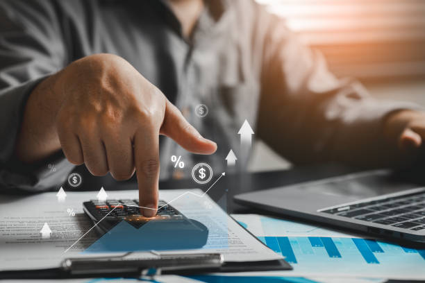 istock Person Using Calculator with Finance Charts and Graphs in Office 2206526508