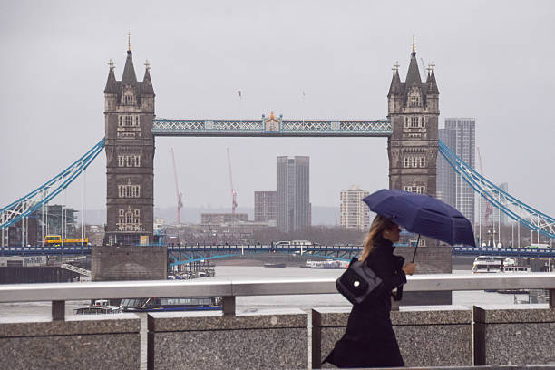 London, UK – 16 November 2025: Urban environment of London, England. Aerial view of London Bridge crossing the River Thames. The bridge carries vehicular traffic. On the southern side is Borough Market, featuring Victorian-era buildings. Nearby stands Southwark Cathedral, a historic Gothic church. Surrounding the area are office buildings and riverside structures.