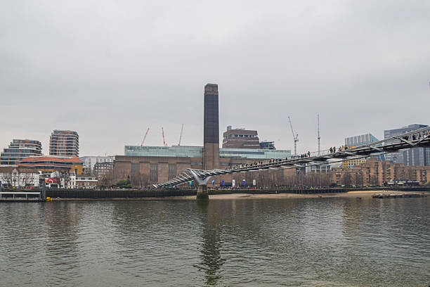 London, UK - March 23 2025: daytime view of Tate Modern, River Thames and Millennium Bridge