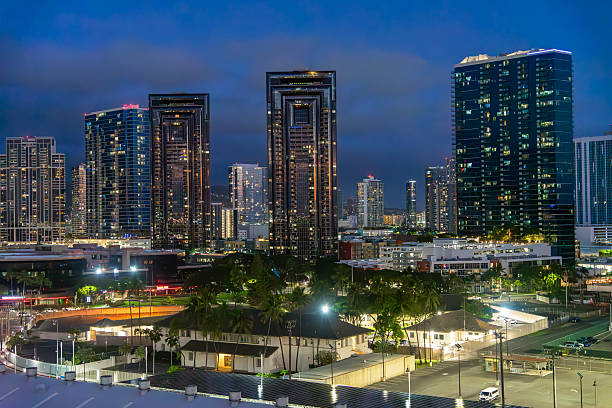 Honolulu, Oahu, Hawaii, USA - February 16, 2025: Twilight in the downtown district in Honolulu, Hawaii, with skyscraper buildings and city lights.