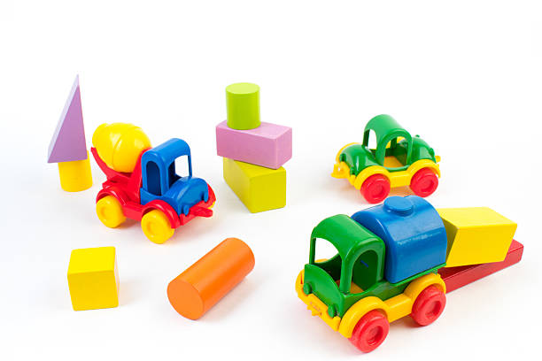 Children's toys, multi-colored car, wooden constructor cubes on a white background. For the development of the child.