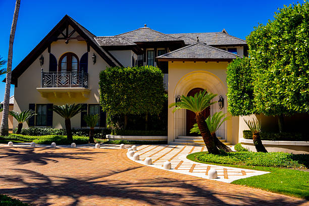 Street in residential area in suburb. Rows of houses along road, sidewalk. Family house outside city. Dream country home. Home outside the city. Road at village. Trees and green lawn at Villa.