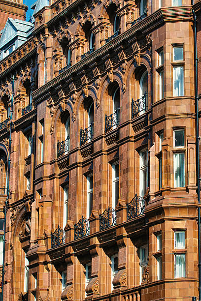 istock Brown Stone Building Facade with Arched Windows and Balconies in Manchester, UK. 2206539771