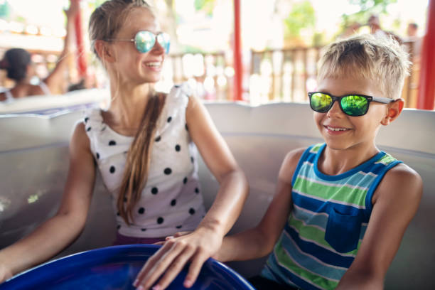 istock Children spinning the wheel on an amusement park ride 2206540835