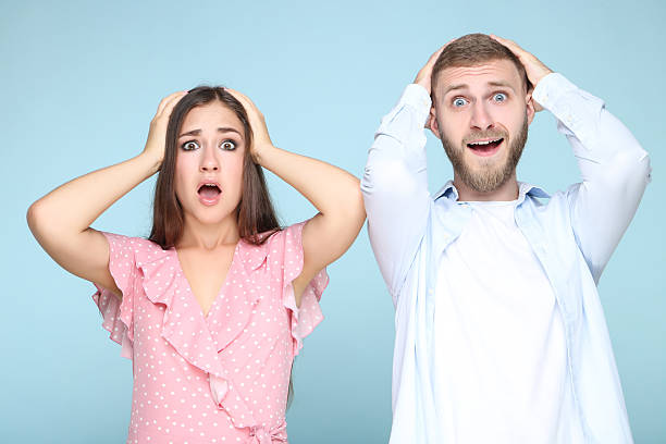 istock Happy young couple on blue background 2206541471