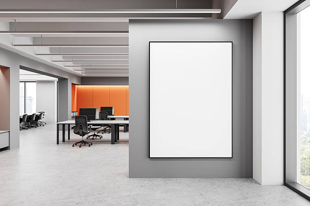 istock Modern office interior with large blank poster mockup on gray wall. 3D Rendering 2206542682