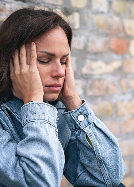 istock Closeup face of stressed woman feeling headache 2206542730