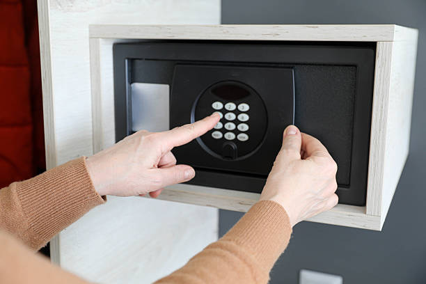 istock Woman Entering Password on Hotel Safe 2206542930