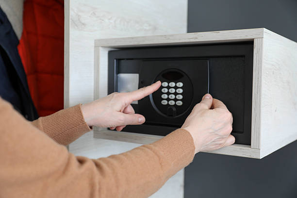 istock Woman Entering Password on Hotel Safe 2206542941