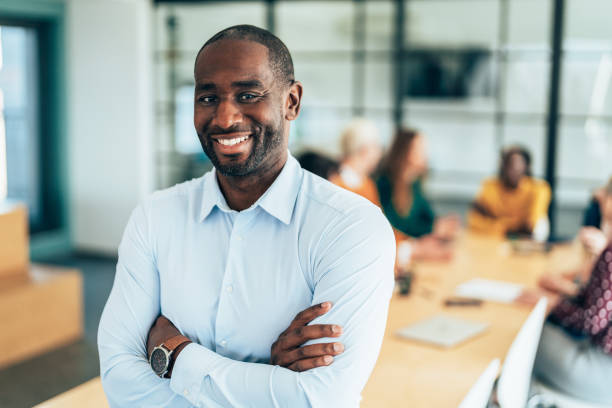 istock Smiling Businessman in a Professional Meeting Environment 2206543097