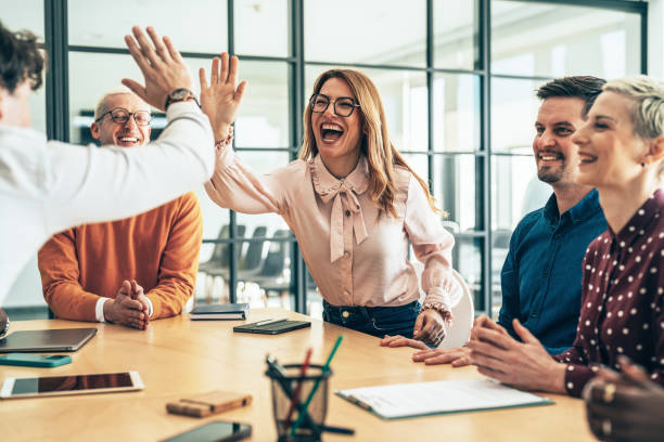 istock High-Five Between Colleagues in a Team Meeting 2206543104