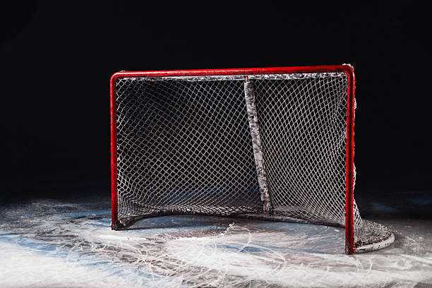 Hockey goal on ice on black background - hockey arena