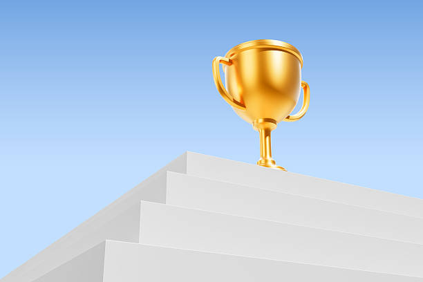 istock Golden trophy on white steps against blue sky. 3D Rendering 2206544225