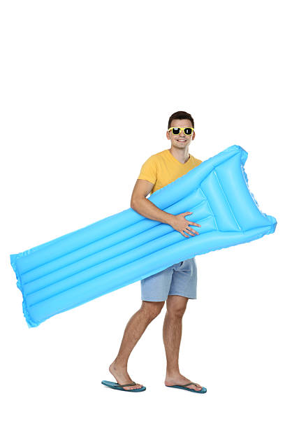 istock Young man with inflatable mattress on white background 2206544257
