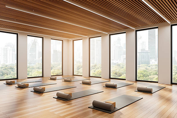 istock Yoga studio with mats and bolsters in modern interior with city view. 3D Rendering 2206544358
