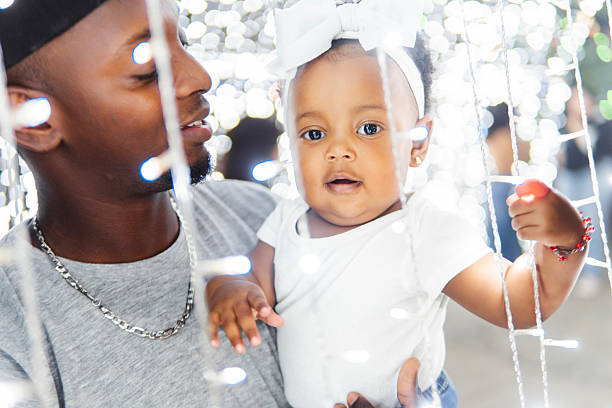 istock Father holding his baby daughter during christmas celebration 2206544421