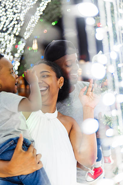 istock Happy family enjoying christmas lights display 2206544423
