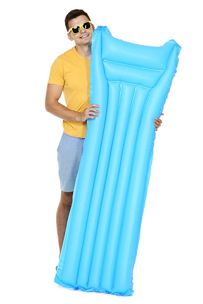 istock Young man with inflatable mattress on white background 2206547147